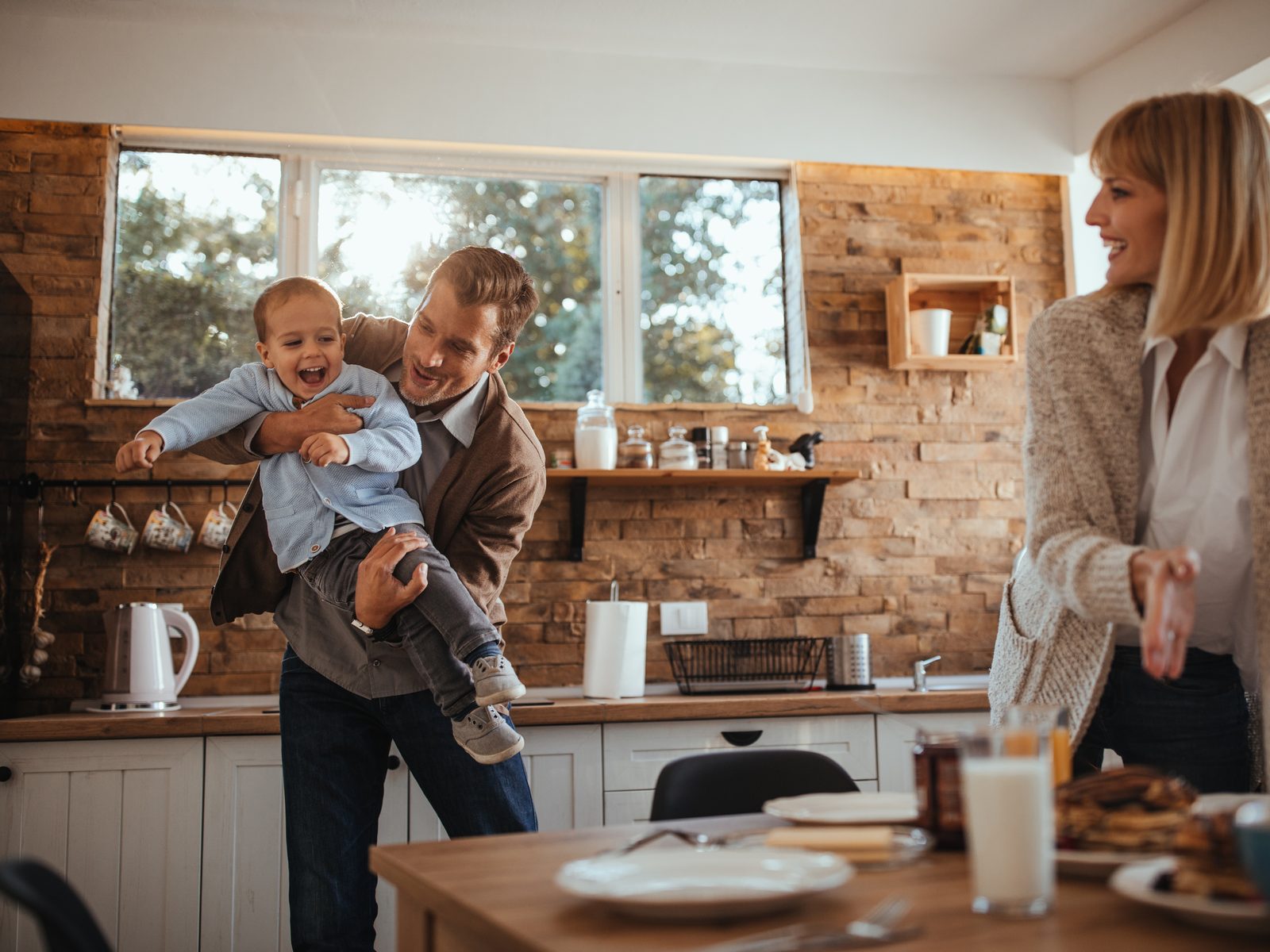 Family laughing together in their kitchen